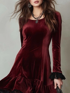 Close-up of wine red velvet dress featuring black lace trim and elegant ruffled hemline
