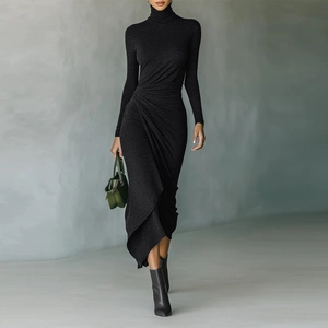 Detail of elegant black dress showing side waist ruching and asymmetrical hemline drape