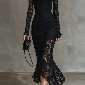 Detail of elegant black floral lace texture on long sleeve dress with ruffle cuff