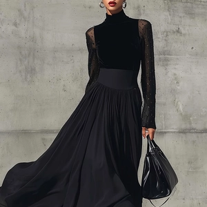 Détail de robe élégante en velours noir avec manches en tulle et jupe plissée