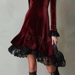 Elegant wine red velvet mini dress featuring intricate black lace trim and long sleeves