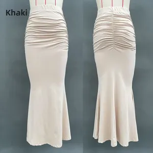 Detail of khaki high waist mermaid skirt showing horizontal pleats and fishtail hem