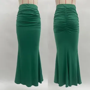 Detail of green ruched mermaid skirt with high waist design and elastic pleated fabric