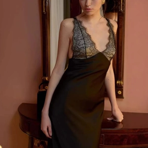Detailed view of elegant black satin dress with delicate eyelash lace trim on V-neckline