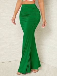 Detail of emerald green high-waisted fishtail skirt with side ruched pleat design