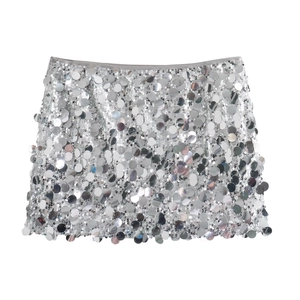 Detailed view of silver mini skirt featuring large reflective sequins for party wear