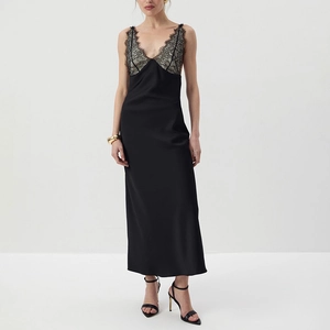 Close-up of black satin dress featuring delicate floral lace details and slim fit straps