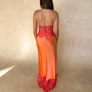 Vue détaillée du dos de la robe en satin orange avec dentelle rouge et dos nu élégant