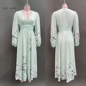 Detail of light green floral V-neck dress with pleated waist and lantern sleeves