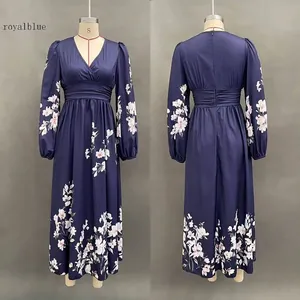 Detail of royal blue floral maxi dress with deep V-neck and pleated long sleeves