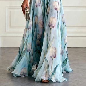 Detailed view of the light blue chiffon dress with realistic blue tulip floral print