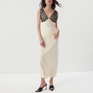 Detail of the black lace neckline and champagne satin fabric on a bodycon midi dress