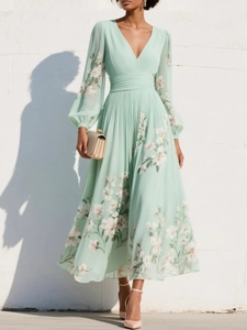 Detail of mint green floral maxi dress with pleated skirt and elegant V-neck design