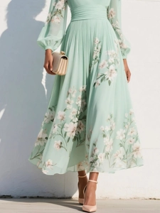 Detail of mint green floral pleated maxi dress featuring high waist and long lantern sleeves
