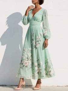Detail of V-neck and high waist pleats on a mint green floral maxi dress with lantern sleeves