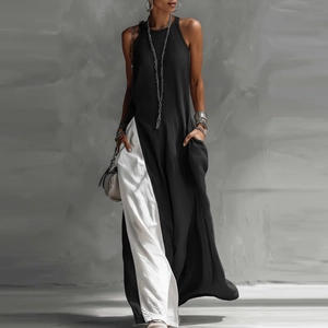 Detail of loose sleeveless dress featuring contrast black and white color blocks with pockets