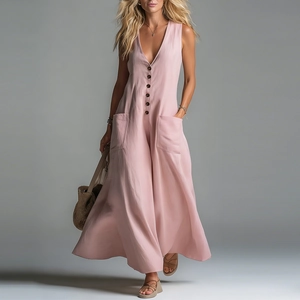 Detail of light pink V-neck jumpsuit featuring large patch pockets and button closure