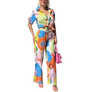 Women's summer two-piece outfit with vibrant tropical print and front-tie shirt