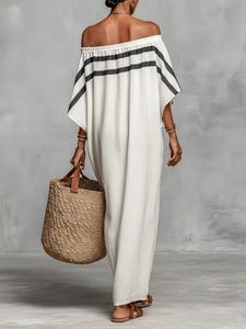 Detail of off-white off-shoulder dress featuring black striped cuffs and linen texture