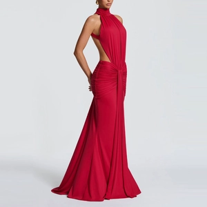 Detail of red halter neck evening dress with ruched waist and elegant knot design
