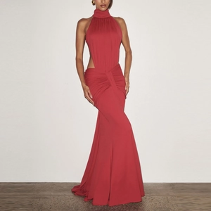 Detail of red halter neck evening gown showing waist cut-out and elegant ruched fabric design