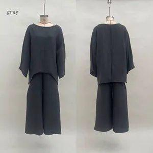 Front and back view of a grey loose casual two-piece set with a curved hemline on a mannequin
