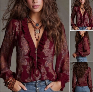 Detail of burgundy paisley chiffon blouse with ruffled V-neckline and zip closure
