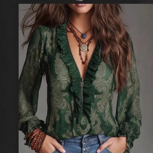 Detail of dark green paisley chiffon blouse featuring deep V-neck with ruffles and zipper