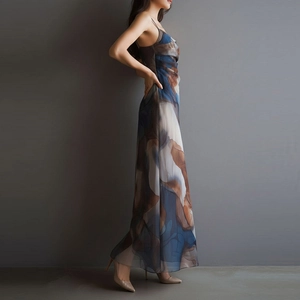 Detail view of abstract print mesh long dress featuring side ruching and elegant drape