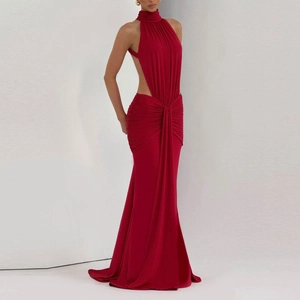 Detail of red halter neck evening gown showing side cutouts and gathered pleats