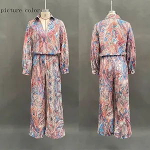 Detail of paisley print two-piece set featuring deep V-neck top and wide-leg trousers