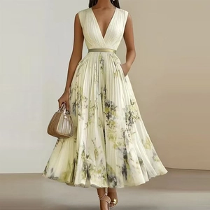 Detail of elegant V-neck sleeveless pleated dress with floral patterns and gold belt
