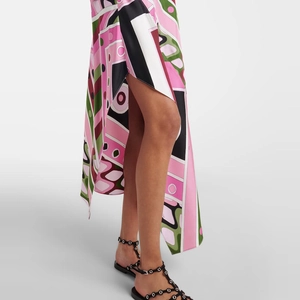 Detailed macro view of geometric print dress hem with high side slit and rivet sandals