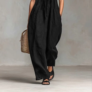 Detail of black wide-leg jumpsuit with waist tie and textured cotton-linen fabric