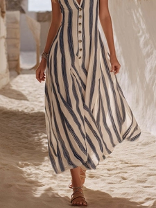 Détail d'une robe longue de plage à rayures bleues et blanches avec col en V et boutons