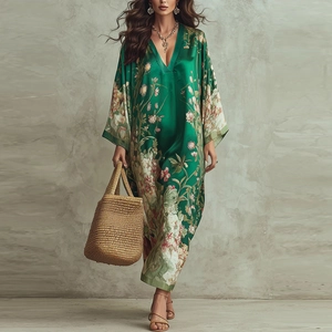 Détail d'une robe maxi bohème avec col en V profond, imprimé floral et texture satinée