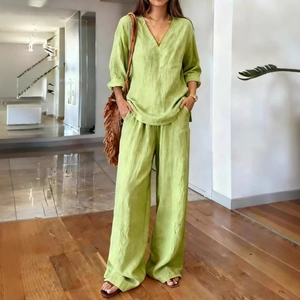 Detail view of grass green cotton linen two-piece set with V-neck top and wide-leg pants