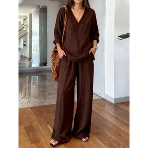 Detail of dark chocolate V-neck loose long sleeve top and matching wide leg pants set