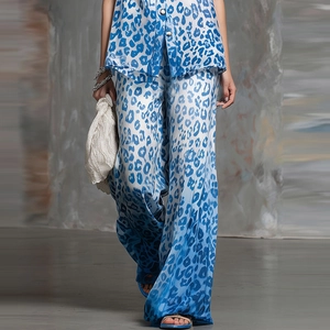 Detail of blue leopard print satin two-piece set featuring loose shirt and wide-leg trousers
