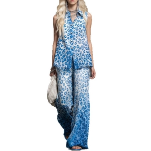 Chic two-piece set with sleeveless leopard print shirt and wide-leg trousers ensemble
