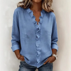 Close-up of light blue blouse featuring elegant ruffles and a classic V-neckline