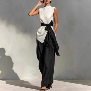 Sleeveless white high-neck top with black wide-leg trousers and bow waist belt set
