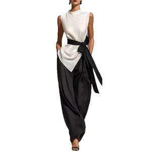 Sleeveless high neck white top with asymmetrical hem and black wide-leg pants set