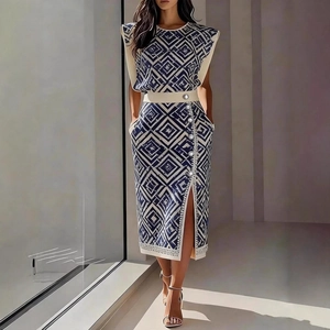 Detail of printed sleeveless top and side slit skirt with decorative silver buttons