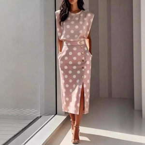 Detail of grey-pink polka dot skirt set featuring decorative gold buttons and a side slit