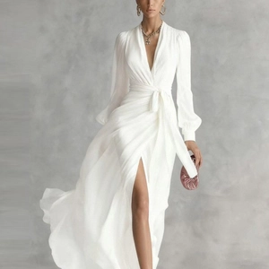 Detail view of white V-neck chiffon dress with high side slit and elegant wrap waist tie