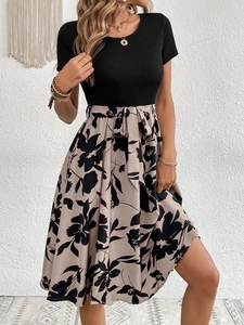 Detail of floral print A-line dress with black knit top and matching bow tie waist