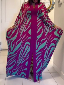 Detail of V-neckline and vibrant 3D zebra print on a loose bohemian beach kaftan