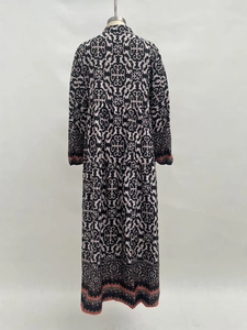 Rear view of tiered maxi dress with bohemian print and orange hem detailing