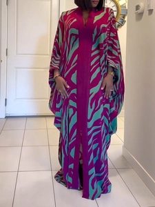 Close-up of lightweight magenta and teal zebra print fabric on the long kaftan dress